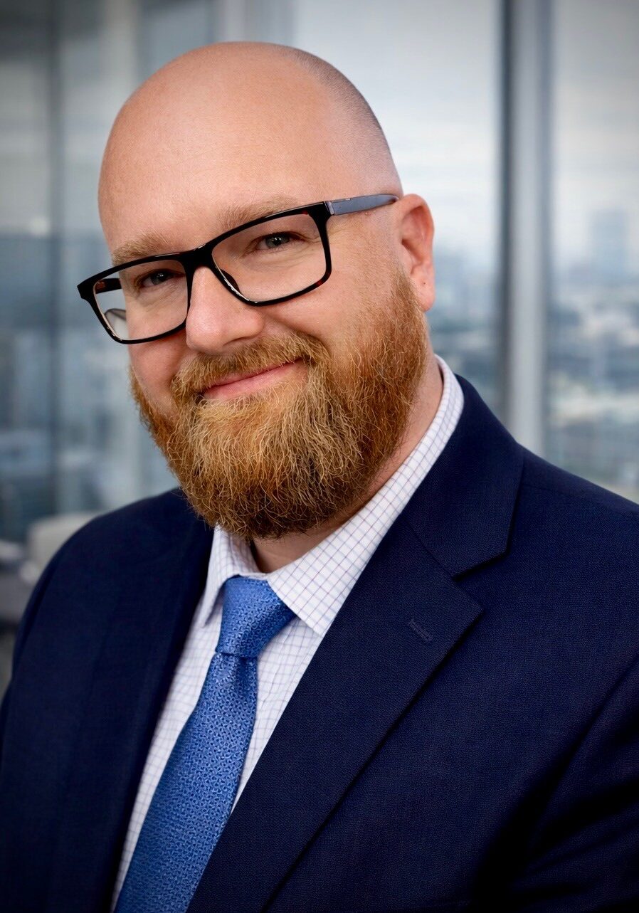 Smiling bald man with beard and glasses